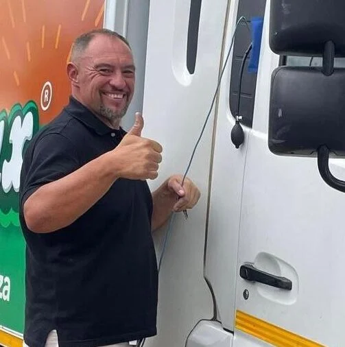 Marcel from Exclusive Locksmiths standing beside a truck and giving a thumbs-up